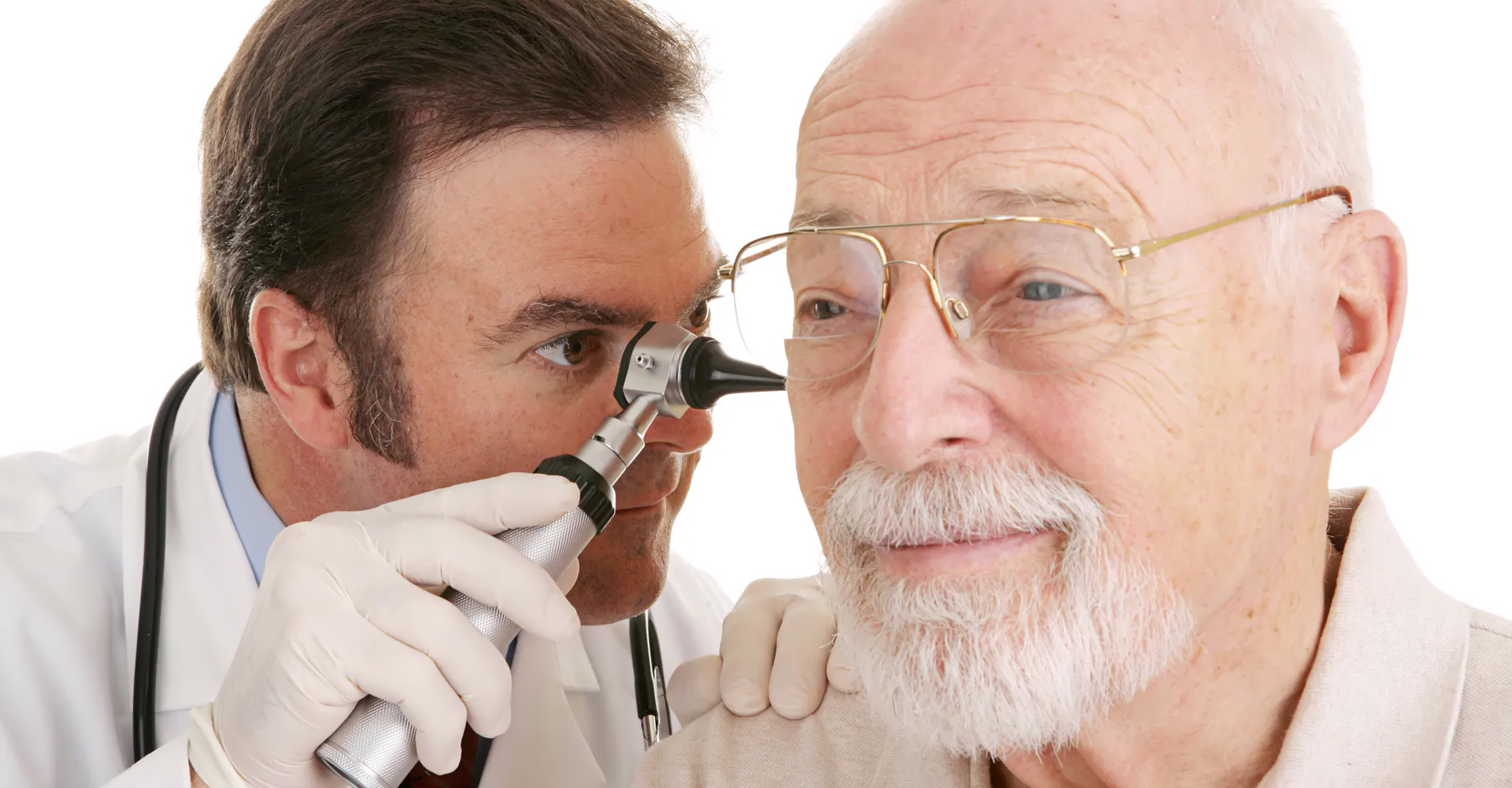 Audiologist performing ear wax removal treatment