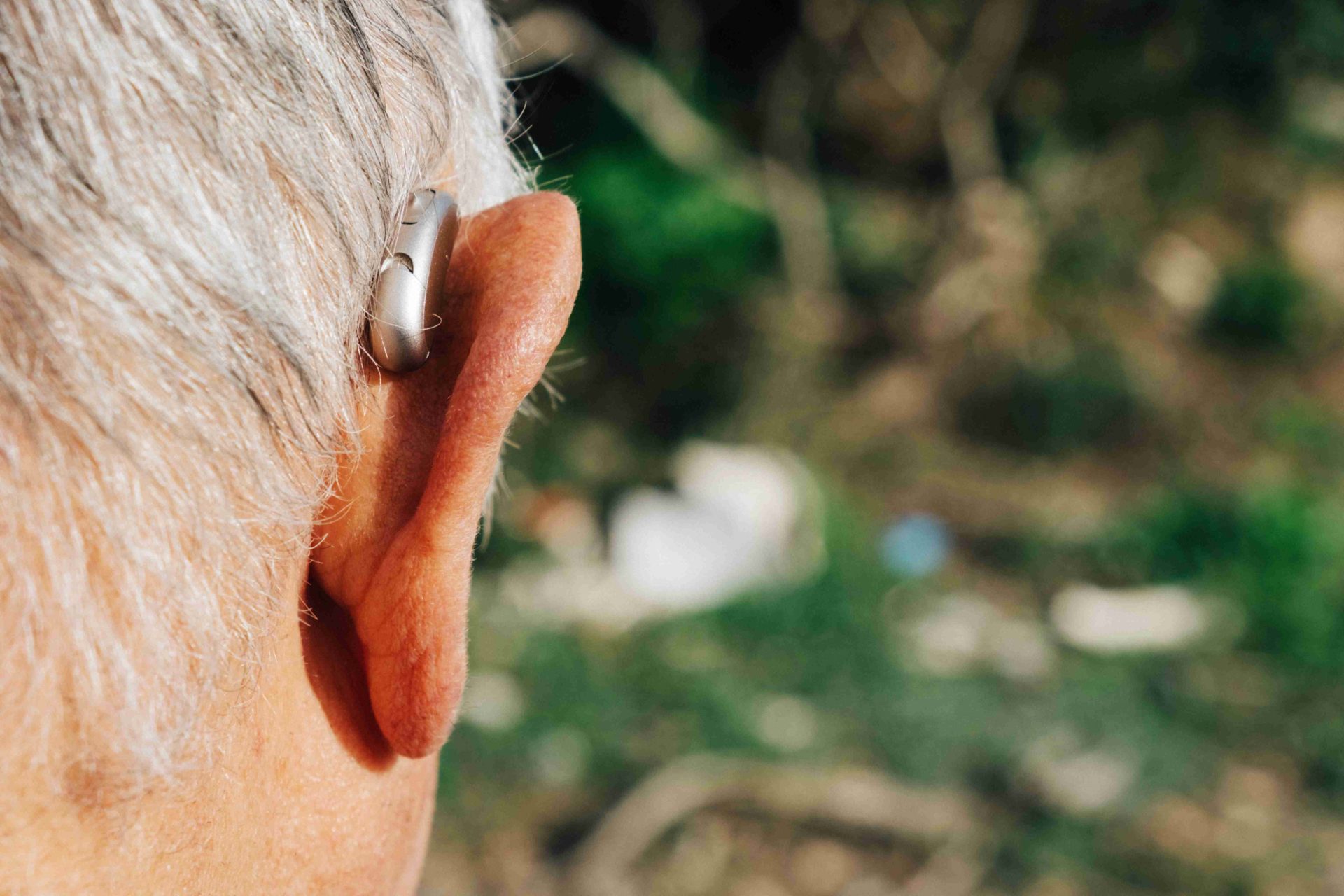 behind the ear hearing aid being worn by a man