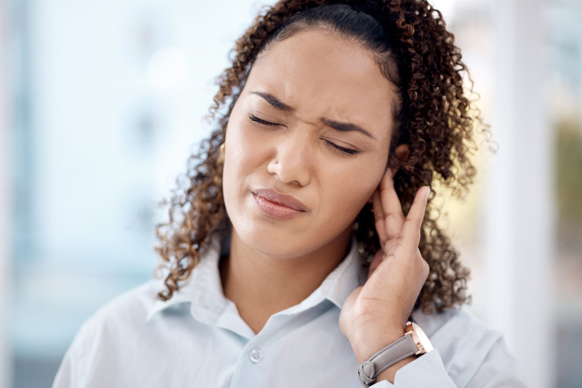 young woman suffering from hearing issue