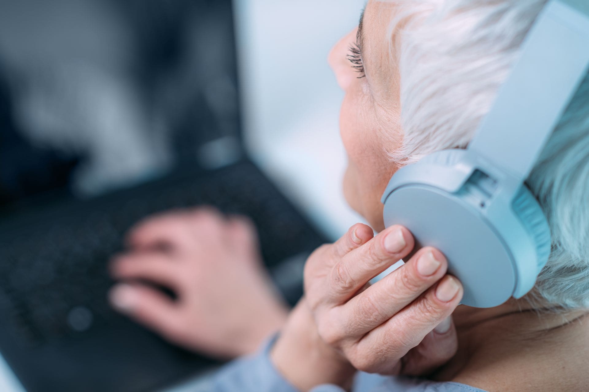 Elderly woman taking online hearing test