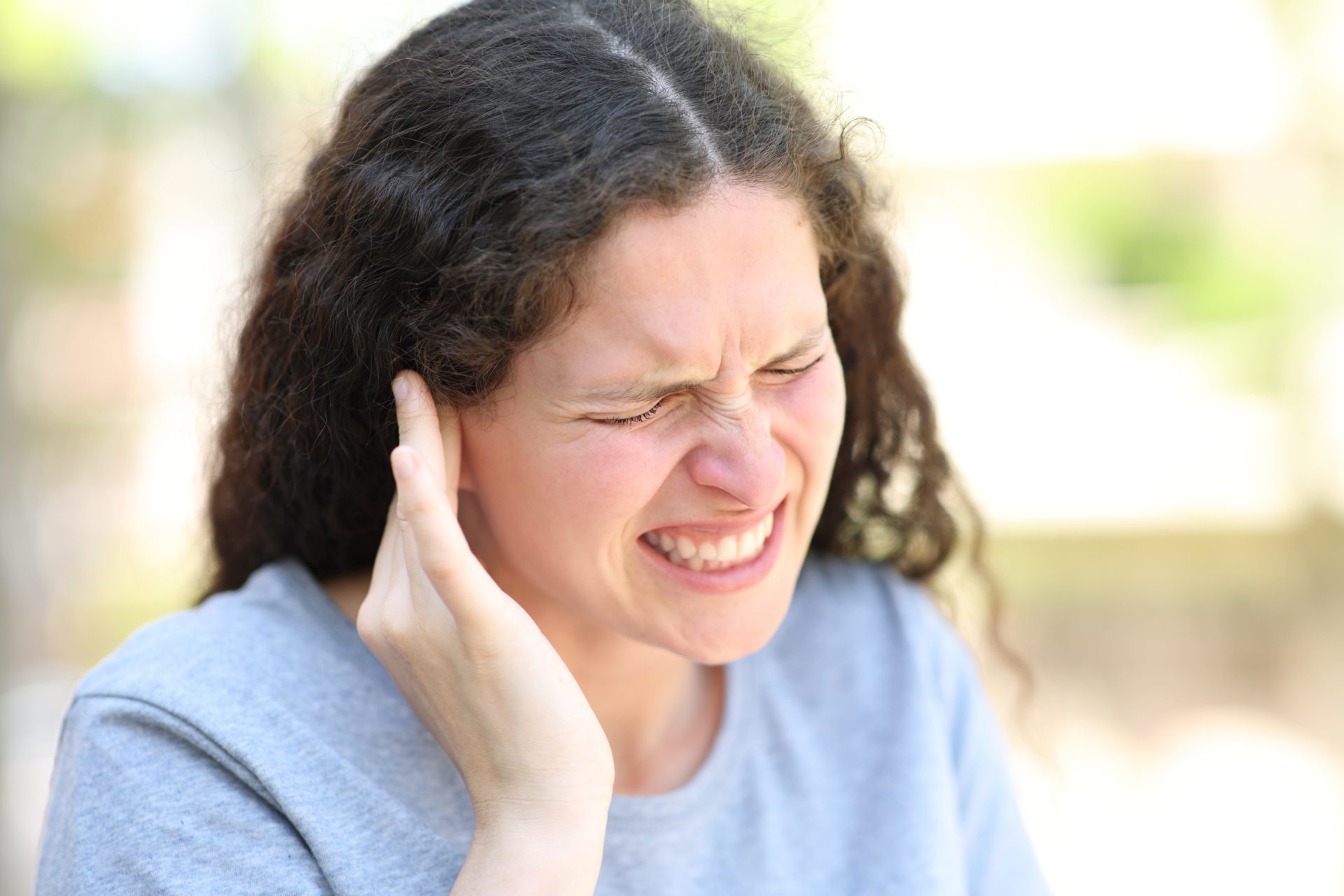 Woman with tinnitus pain