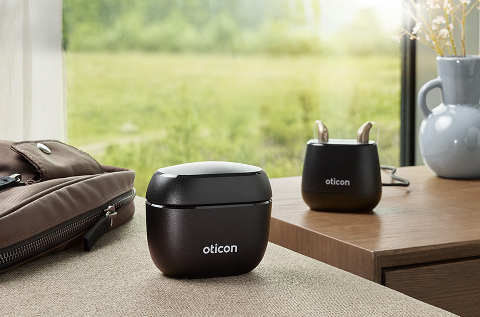 Oticon intent hearing aid in it's charging port.